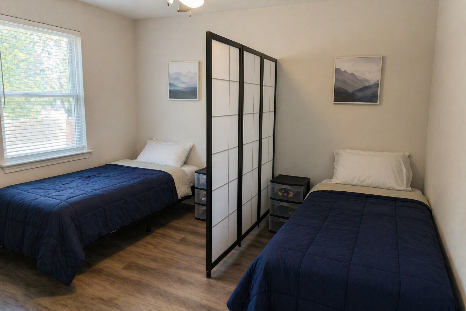 Shared DALS bedroom with two twin beds and a divider between residents